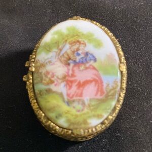 Solid perfume oval shaped locket of 2 women hugging.,full of solid perfume.